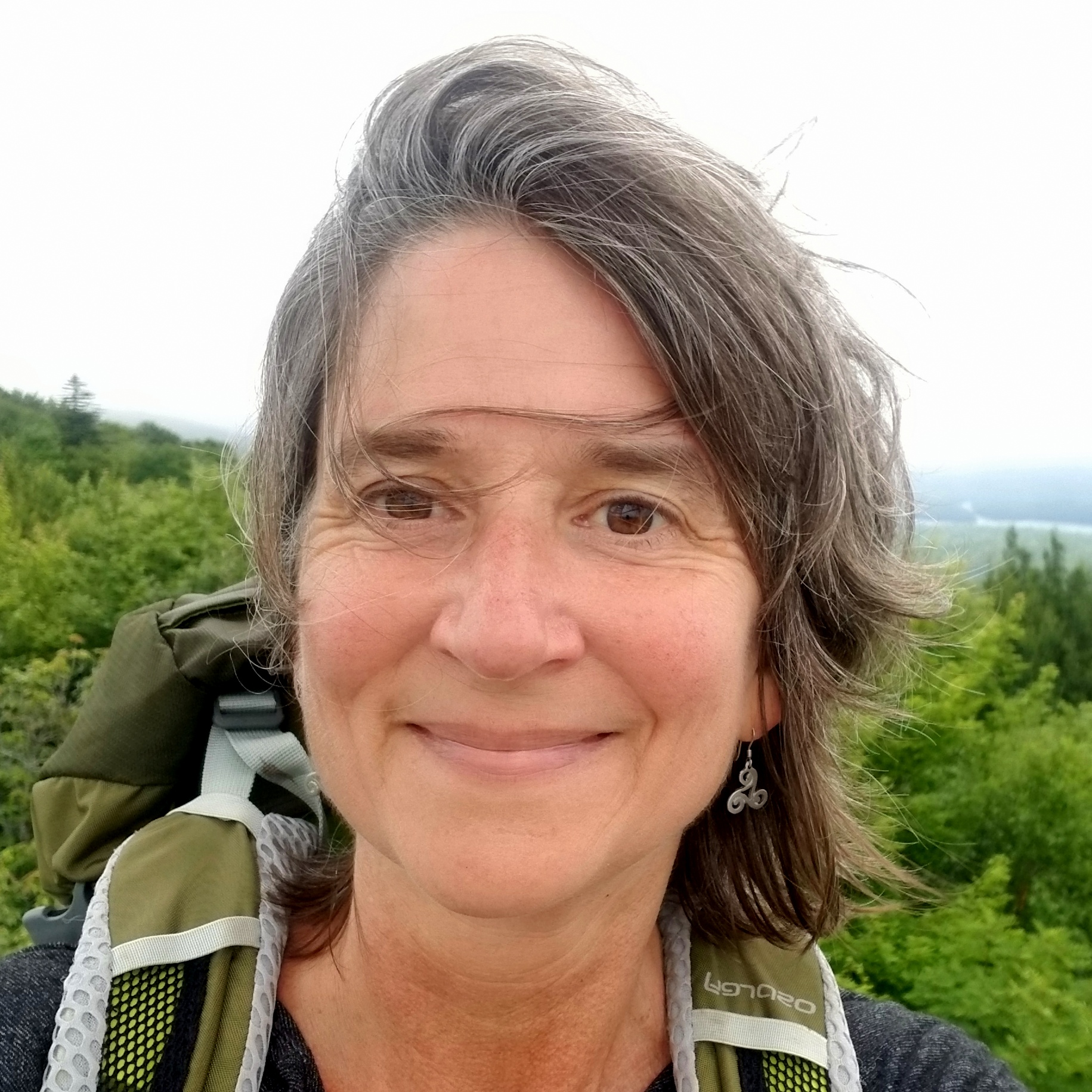Find Hidden Gems of the Finger Lakes Region - Move Slowly and Narrow Your Focus a woman with a backpack